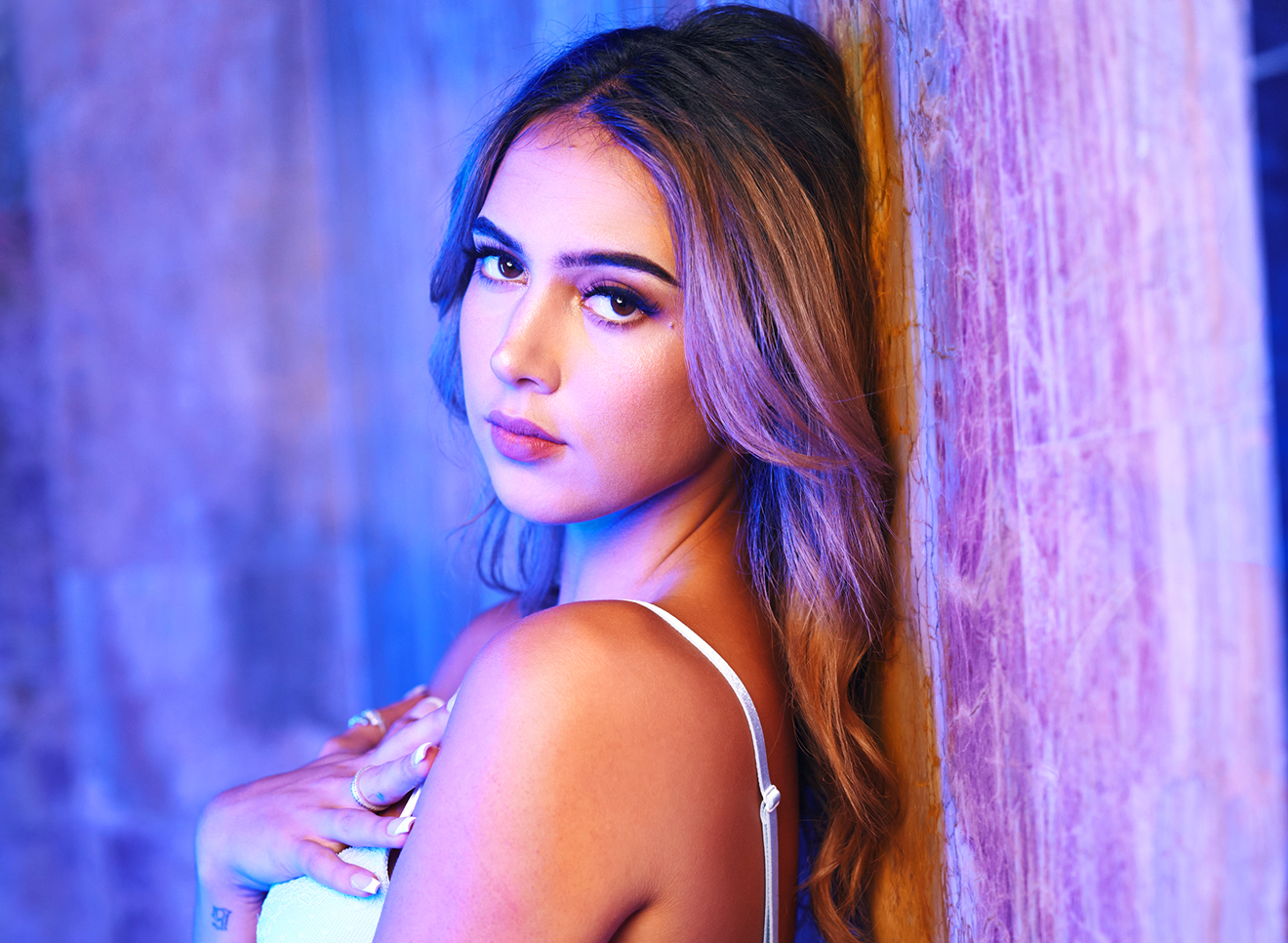 Portrait of woman leaning on wall