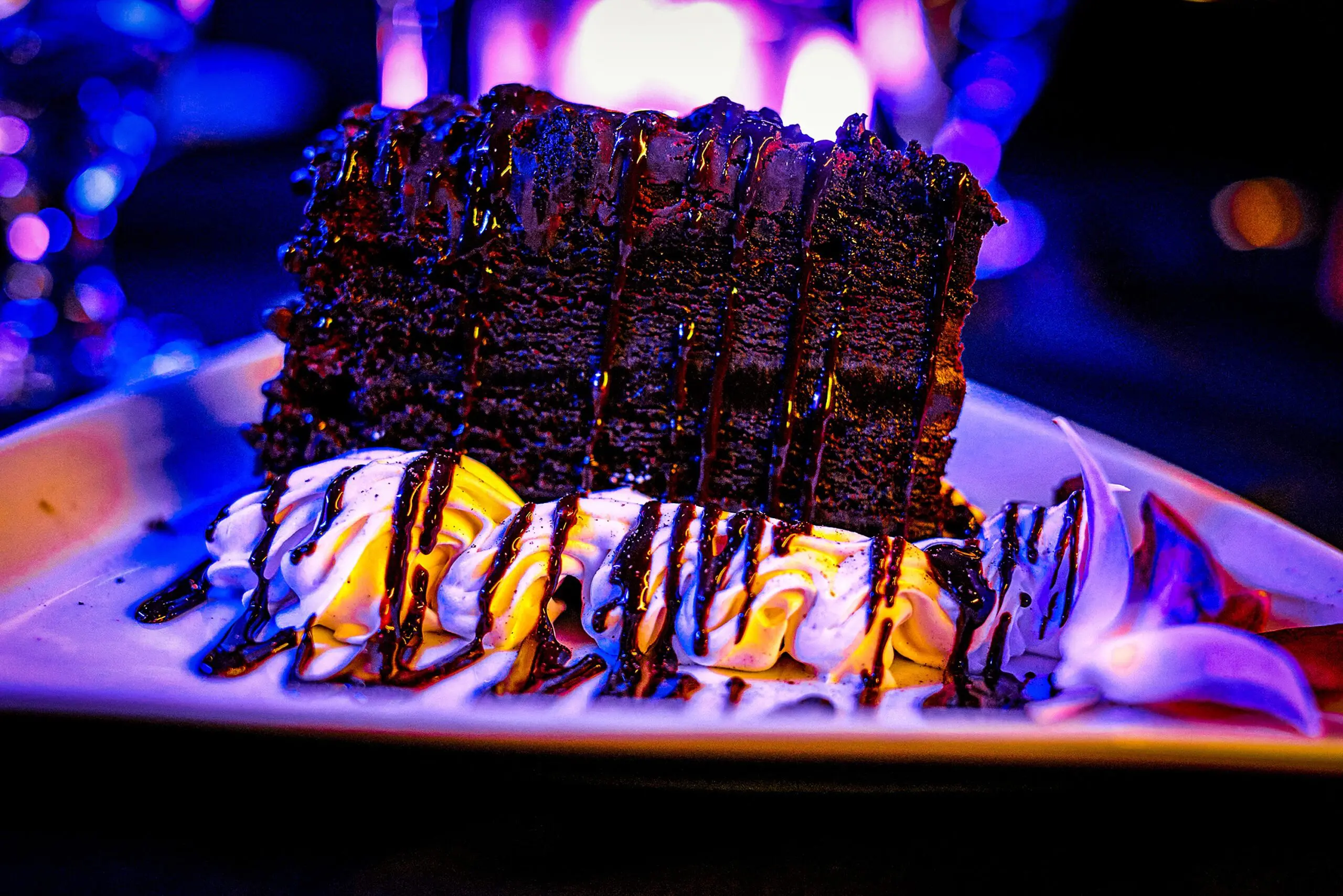 Indulgent cake drizzled with chocolate sauce