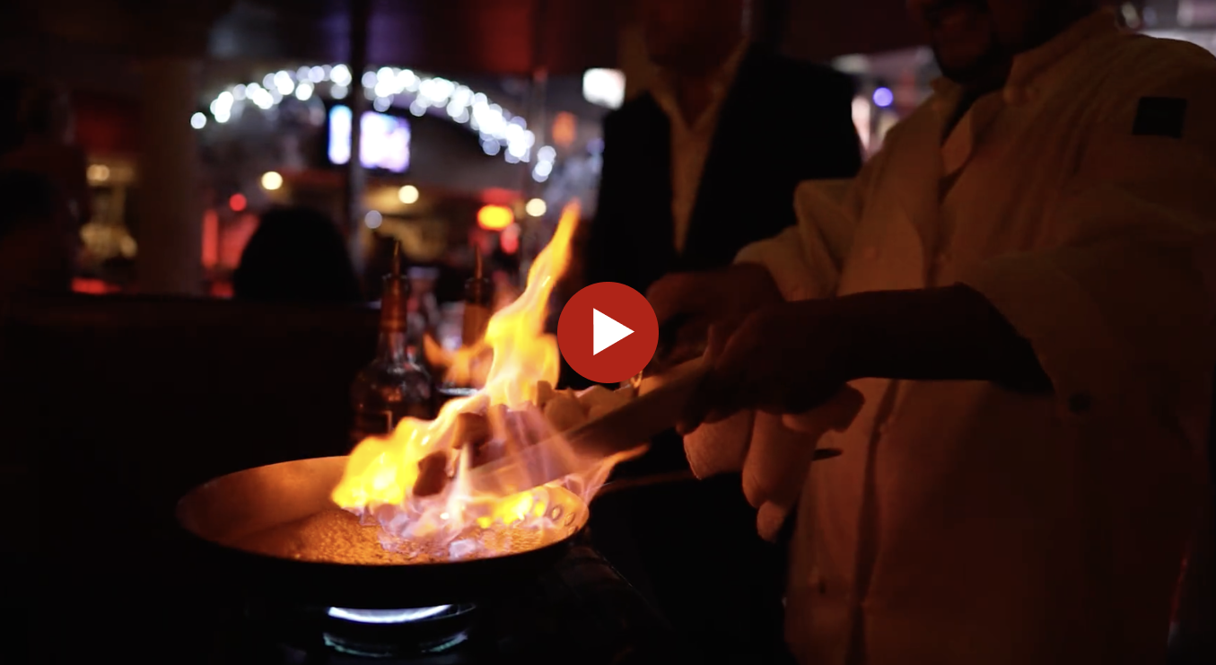 Chef flambéing dish at restaurant