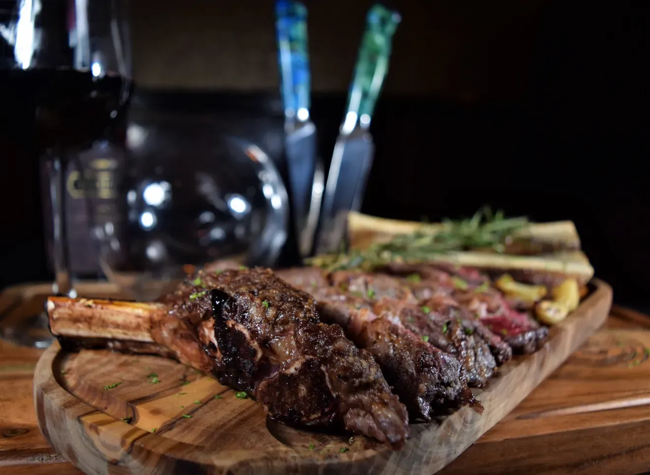 Grilled steak with herbs on wooden board